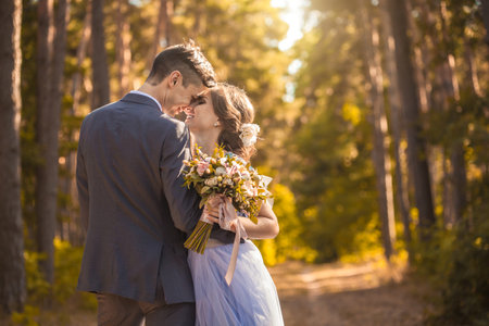 happy bride and groom walking on the autumn beachの写真素材