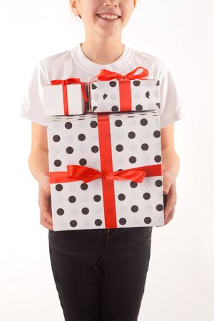 little girl with gift boxes in handsの写真素材