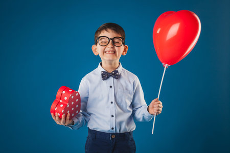 Cute kid with gifts on the blue background
