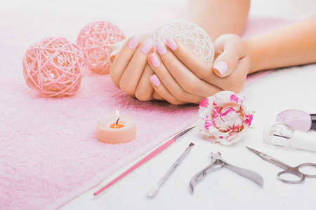 beautiful pink manicure with rose,manicure set, on the white and pink towelsの写真素材