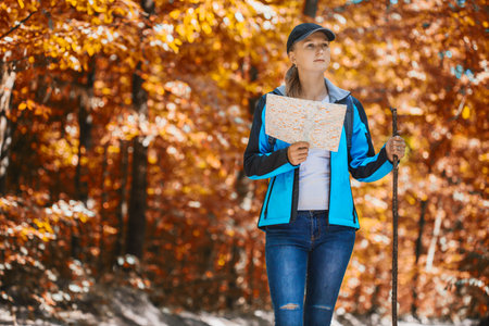 young woman walks in a autumn pinewood.