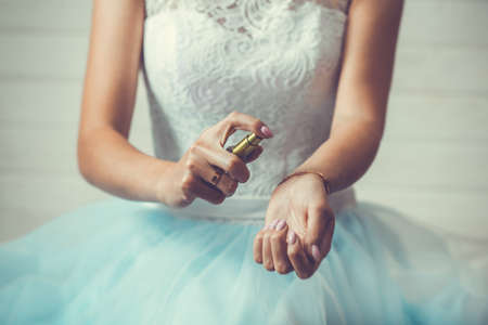 bride applying perfume on her wristの写真素材
