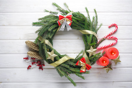 handmade christmas wreath with pine needles, candles, sweets