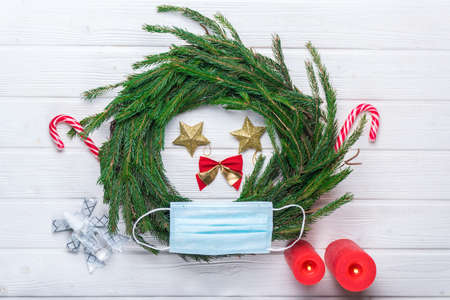 handmade  christmas wreath with pine needles, candles, sweetsの写真素材