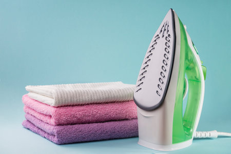 Steam iron isolated on the blue background
