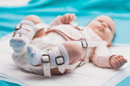 A baby wearing a harness that corrects hip dysplasiaの写真素材