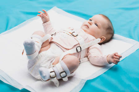 A baby wearing a harness that corrects hip dysplasiaの写真素材