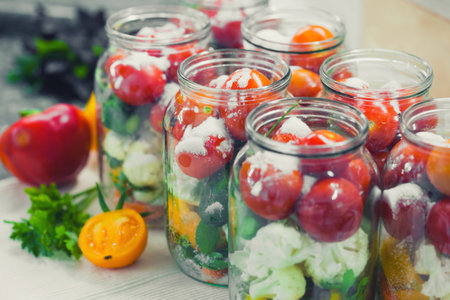 The process of preserving cucumbers and tomatoes for the winter.の写真素材