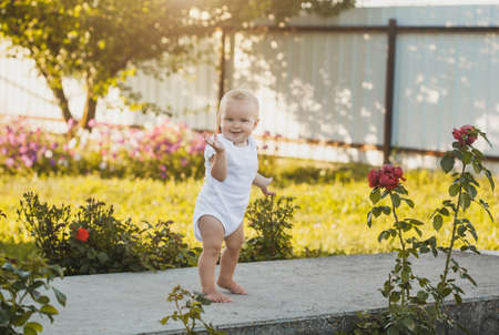 one year old baby girl in a blooming gardenの写真素材