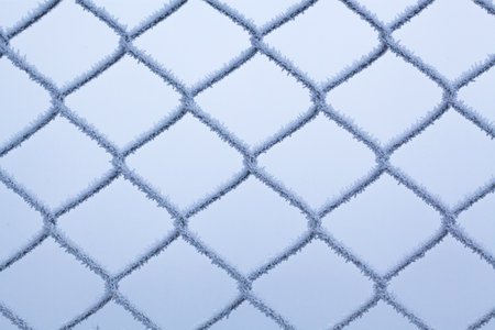 Frost on a metal grid against a winter background. Selective focus.の写真素材