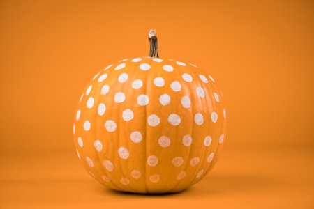 polka dots Orange pumpkin on orange background. haloween concept.の写真素材