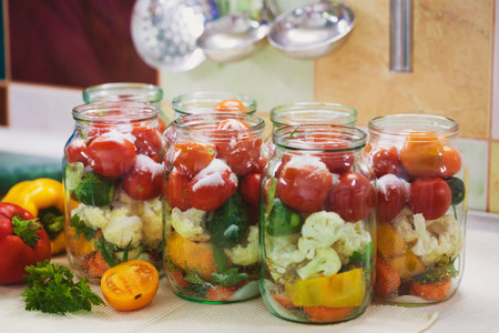 The process of preserving cucumbers and tomatoes for the winter. selective focusの写真素材