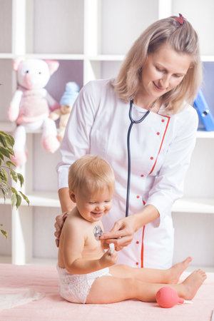 Doctor examining little baby with stethoscope in clinic. Baby health conceptの写真素材