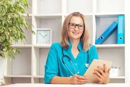 Young female doctor in a turquoise coatの写真素材