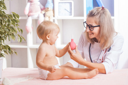 Woman Doctor examining little baby in clinic. Baby health medicine conceptの写真素材