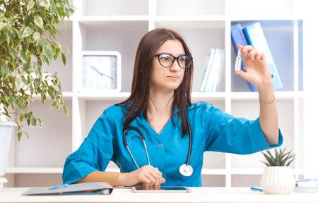 Young female doctor working in hospital office. Medical and healthcare concept.の写真素材