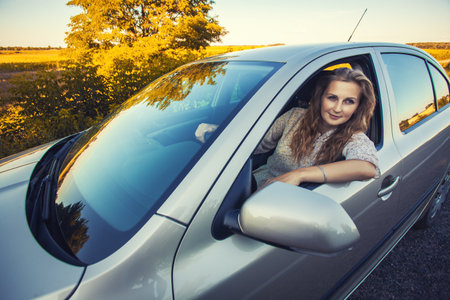beautiful blonde talking in the car. breakdown on the road. road tripの写真素材