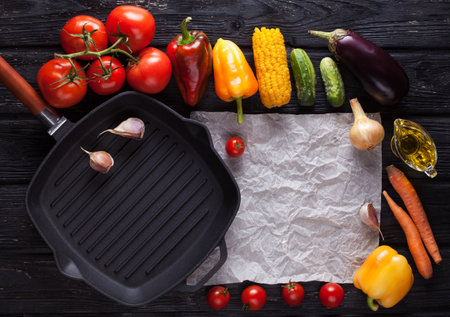 Background of grilled vegetables on a grill pan. On the black wooden table. horizontal top viewの写真素材