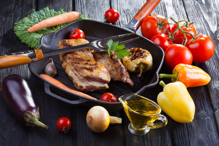 loin on the bone grill pan with fresh vegetablesの写真素材
