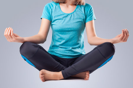 young woman doing yoga. studio photoの写真素材