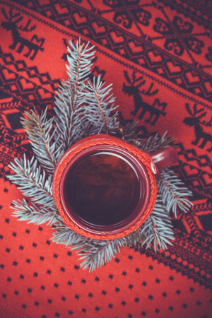 blue sweater hot cup of tea, Christmas tree and New Year's decoの写真素材