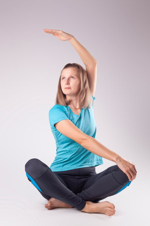 young woman doing yoga. studio photoの写真素材