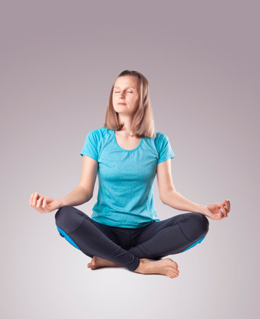 young woman doing yoga. studio photoの写真素材