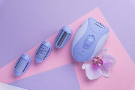top view of Modern epilator on purple background. skin care, removal of unwanted hair.の写真素材