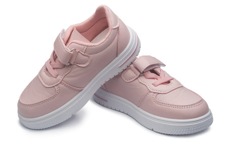 pink leather sneakers on isolated on a white background. childrens sports shoesの写真素材