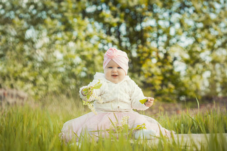 little girl on a blooming spring meadowの写真素材
