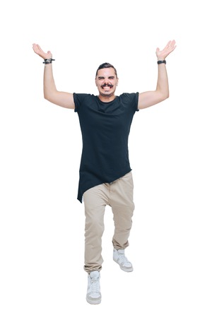 Young man in a black shirt as if holding a heavy object in his outstretched hands up over his headの写真素材