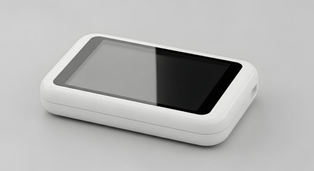 A sleek, white digital device with a reflective black screen, presented on a neutral gray surface.の素材