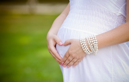 Beautiful pregnant woman relaxing in the park の写真素材