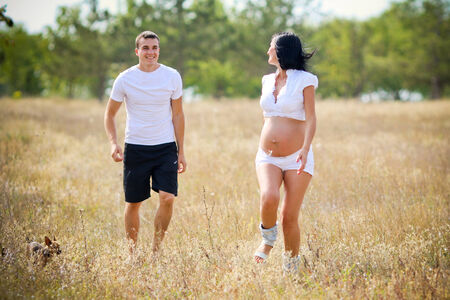 the husband catches up with the pregnant wifeの写真素材