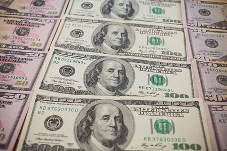 One hundred dollars pile as backgroundの写真素材