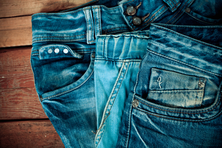 Blue jeans pocket  on wooden backgroundの写真素材