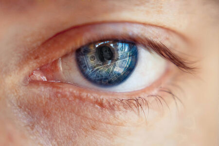 Dollar sign in human pupil. Greed concept.の写真素材