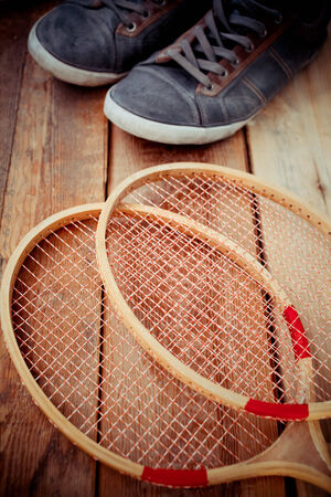 Vintage wood tennis racket on aged woodenの写真素材