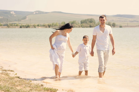 young family with a sun on the natureの写真素材