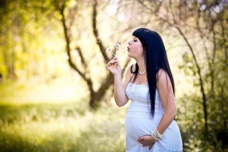 Beautiful pregnant woman relaxing in the parkの写真素材