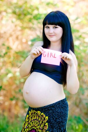 Beautiful pregnant woman relaxing in the parkの写真素材