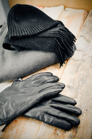 man cap and gloves on a wood background