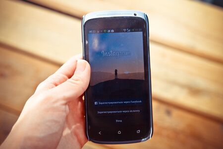 YALTA, CRIMEA, RUSSIA - DECEMBER 05, 2014: Instagram login screen smartphone  application on  wood background.のeditorial素材