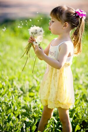 little girl closeup portrait with dandelionの写真素材