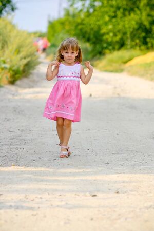 running open arms little happy girl green meadow field trackの写真素材