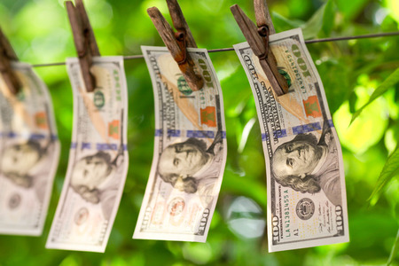 Money laundering concept with dollars on the ropeの写真素材