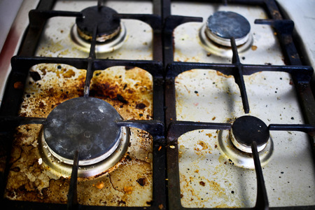 Dirty filthy gas stove in kitchenの写真素材