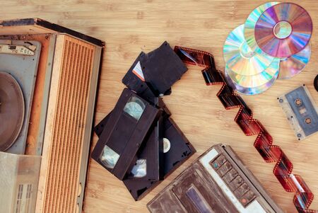 Old subjects of 80-90 years:   video of the cartridge, disks, the cartridge and a film on a wooden backgroundの写真素材