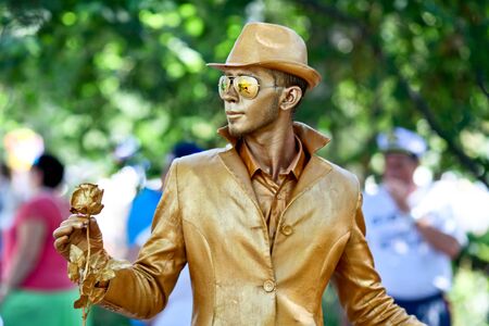 Sevastopol, Russian Federation-26 of July, 2015: Street artist dressed as a gold statue takes up an position,in honor of a holiday of navy of Russiaのeditorial素材
