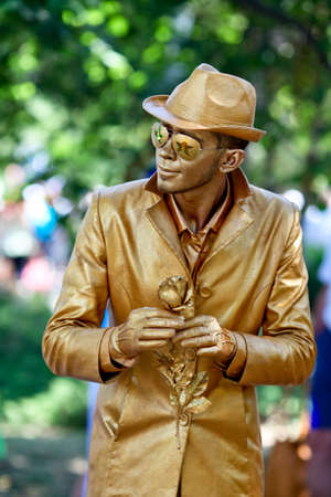 Sevastopol, Russian Federation-26th of July, 2015: Street artist dressed as a gold statue takes up an position, in honor of a holiday of navy of Russiaのeditorial素材